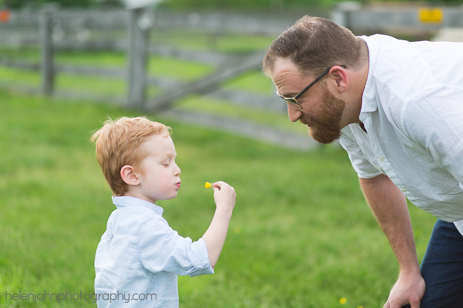 Little boy showing his dad a flower