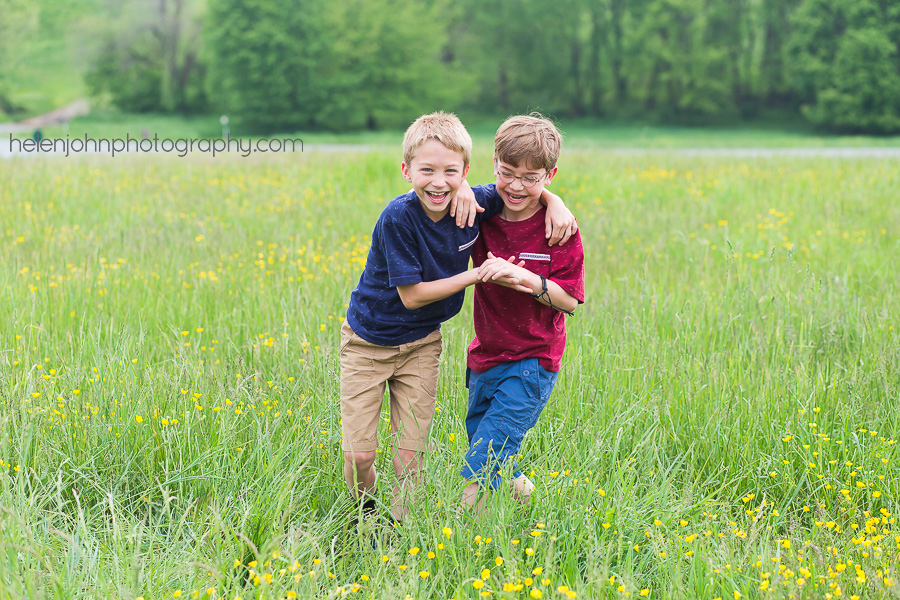Two boys hugging in a field