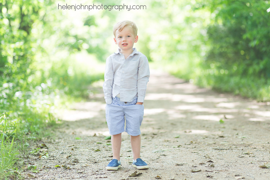 Little boy standing on a gravel road