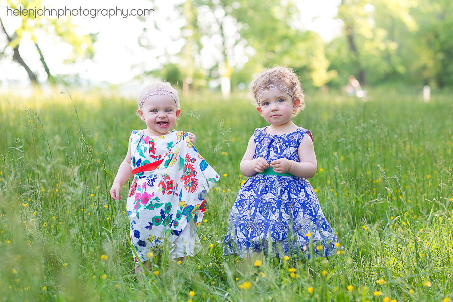 Twin girls playing outside in a field