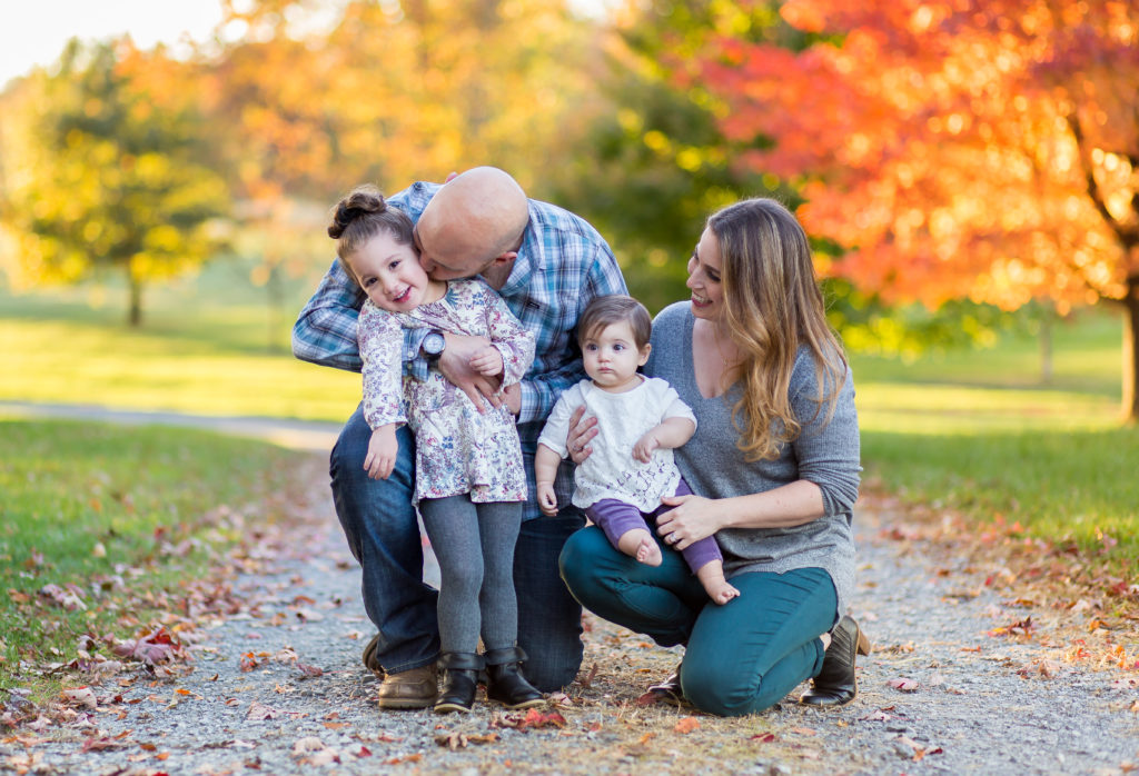 family of four in front of gorgeous fall colors