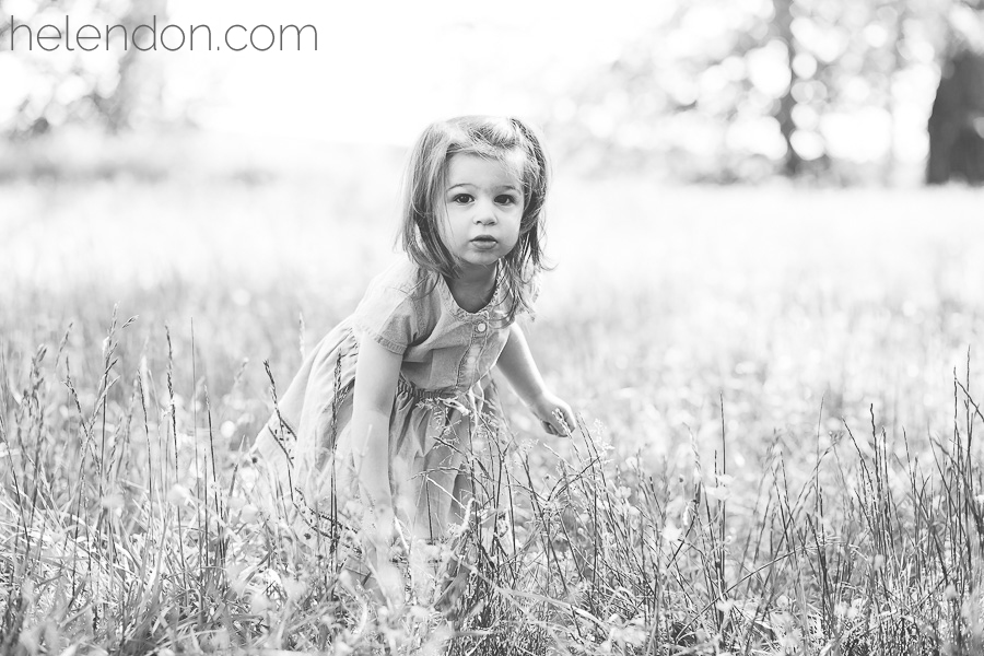 Little girl playing in the grass