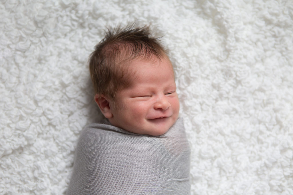 newborn baby laughing