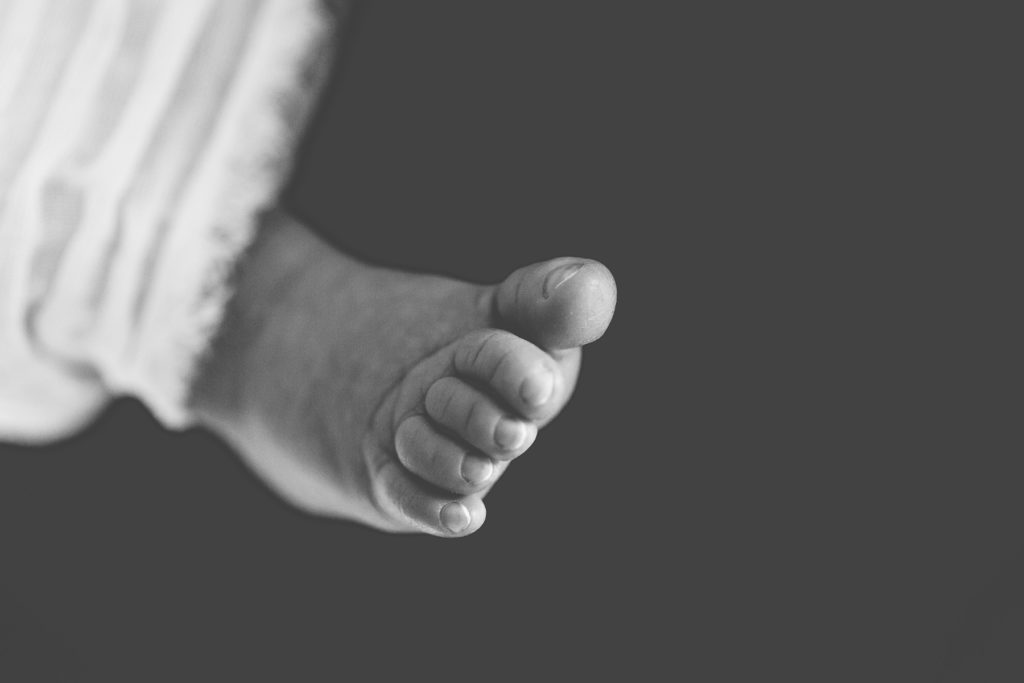 close up of newborn toes black and white