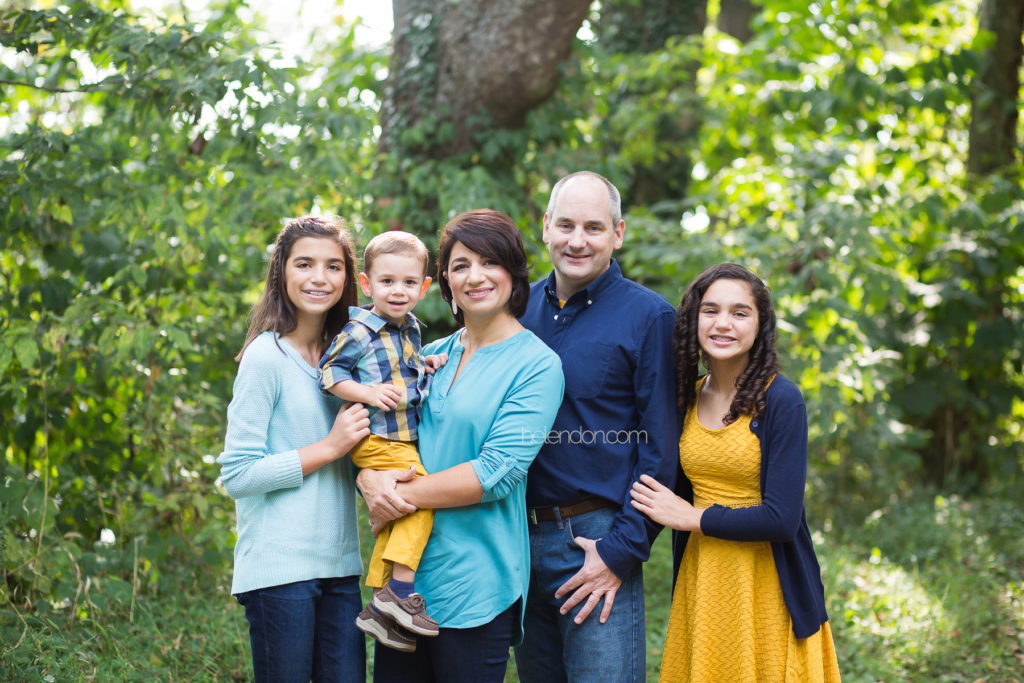 family of five outdoors smiling