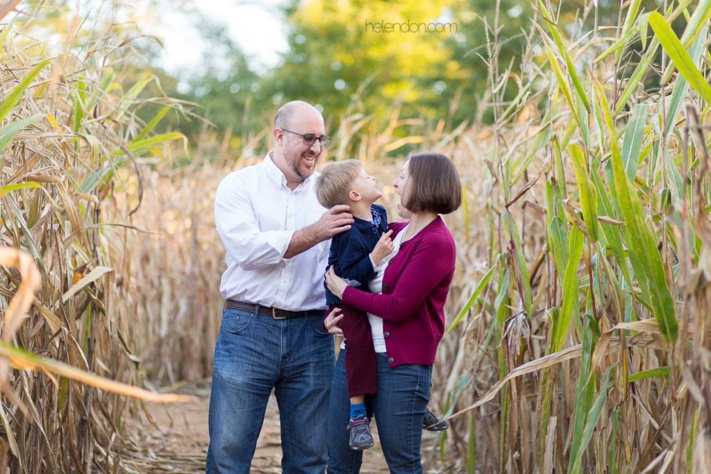 family laughing together in corn field
