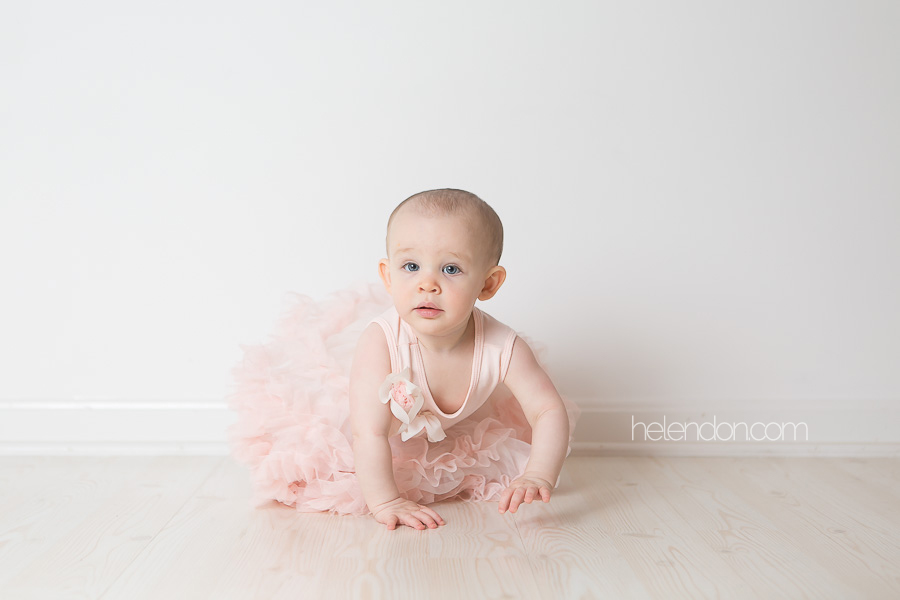 adorable one year old girl in pink tutu