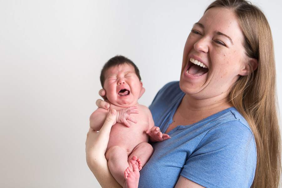 newborn crying and mom laughing