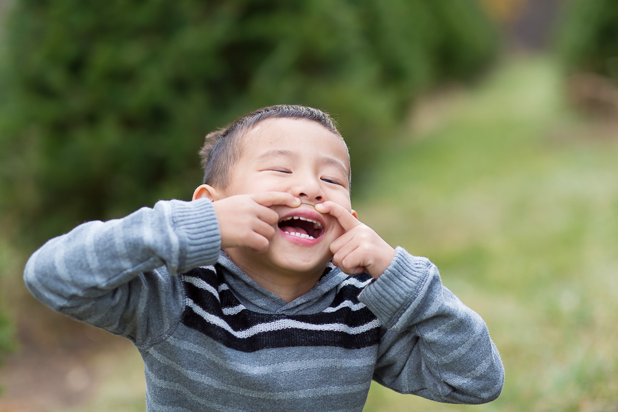 4 year old with pretend mustache laughing
