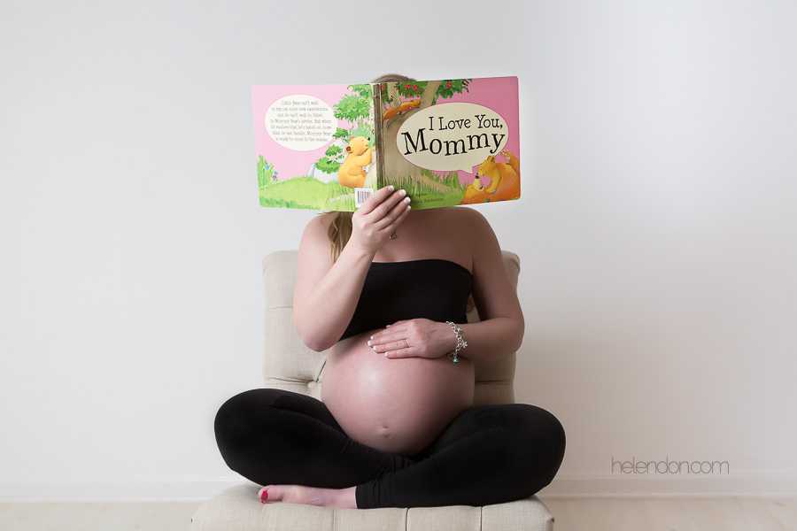 pregnant woman reading i love you mommy book