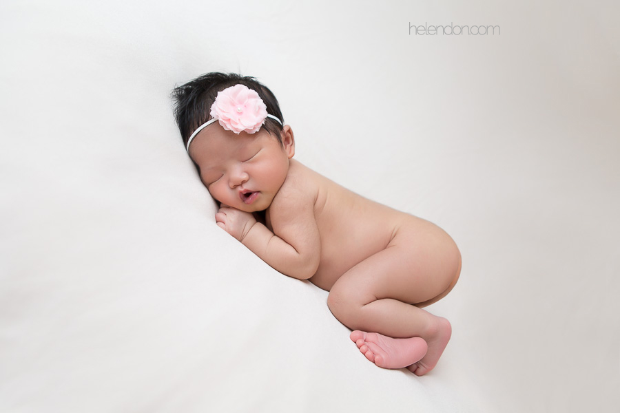 newborn girl sleeping on bean bag