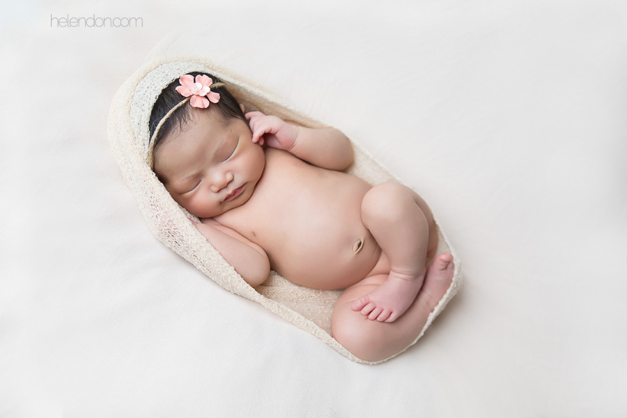 newborn girl sleeping with pink headband