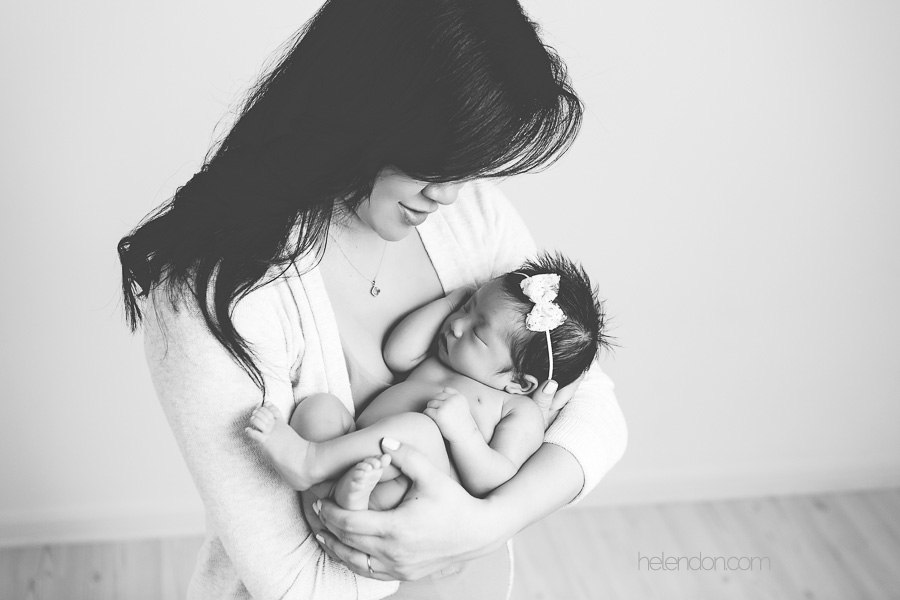 black and white photo of mother holding newborn girl