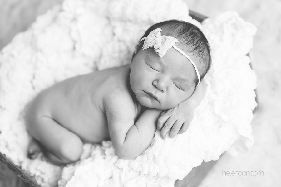 blacka nd white photo of newborn with headband