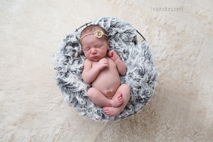 newborn baby girl sleeping in metal basket
