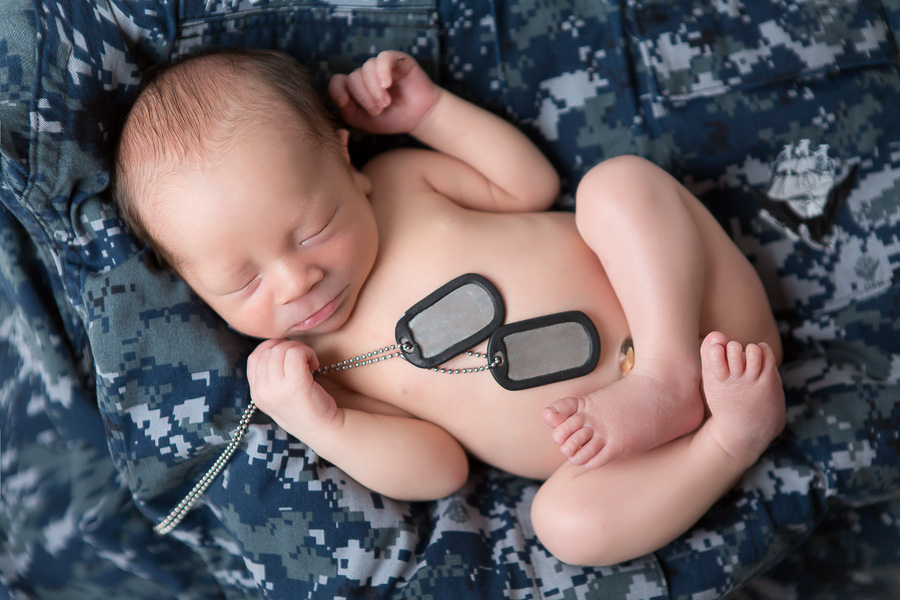 army tags on sleeping newborn