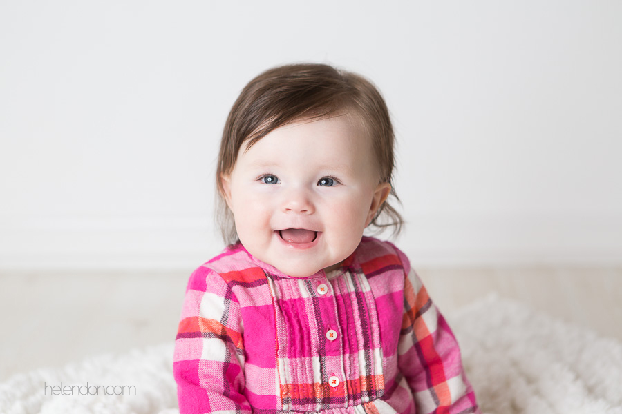 adorable baby girl in pink shirt smiling