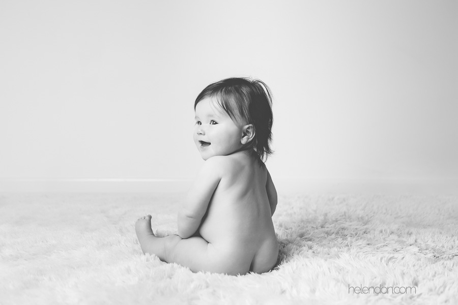 black and white of adorable baby girl laughing