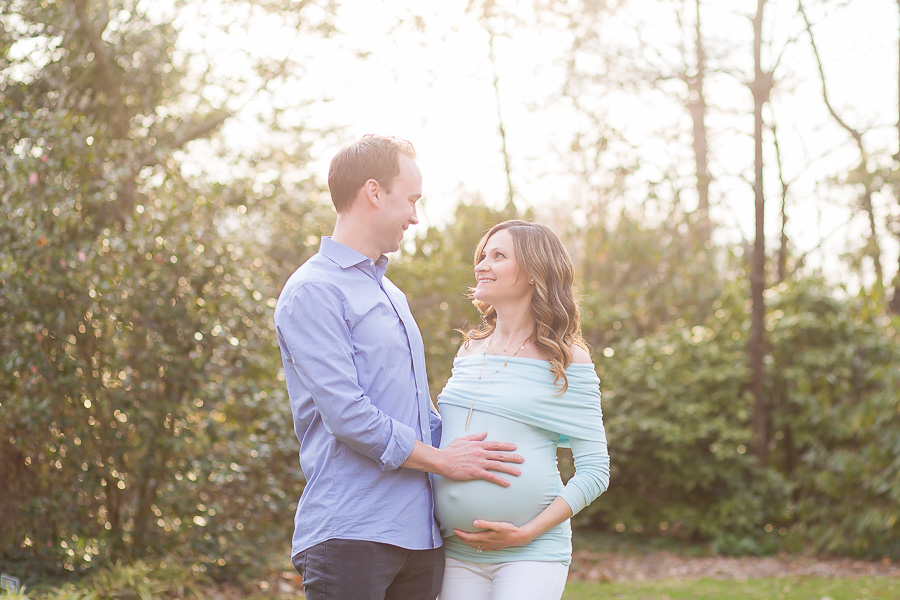 pregnant couple smiling at each other