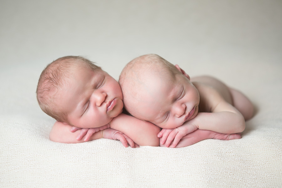 newborn twins sleeping side by side