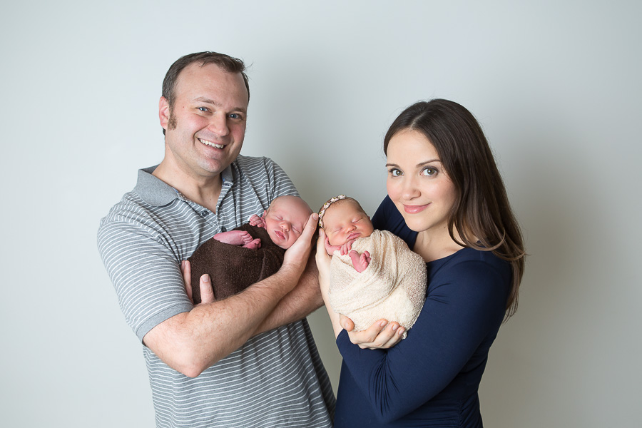 parents holding newborn twins