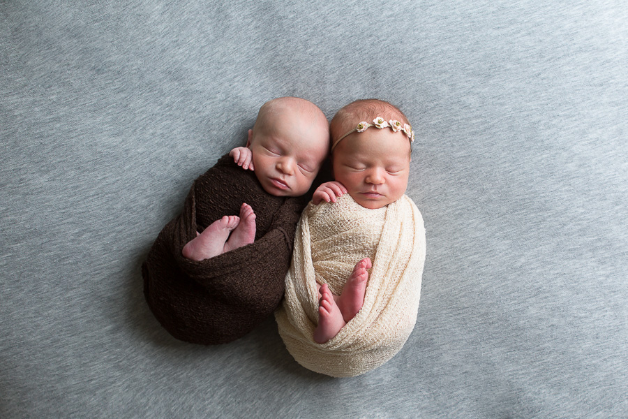 newborn twins boy and girl swaddled