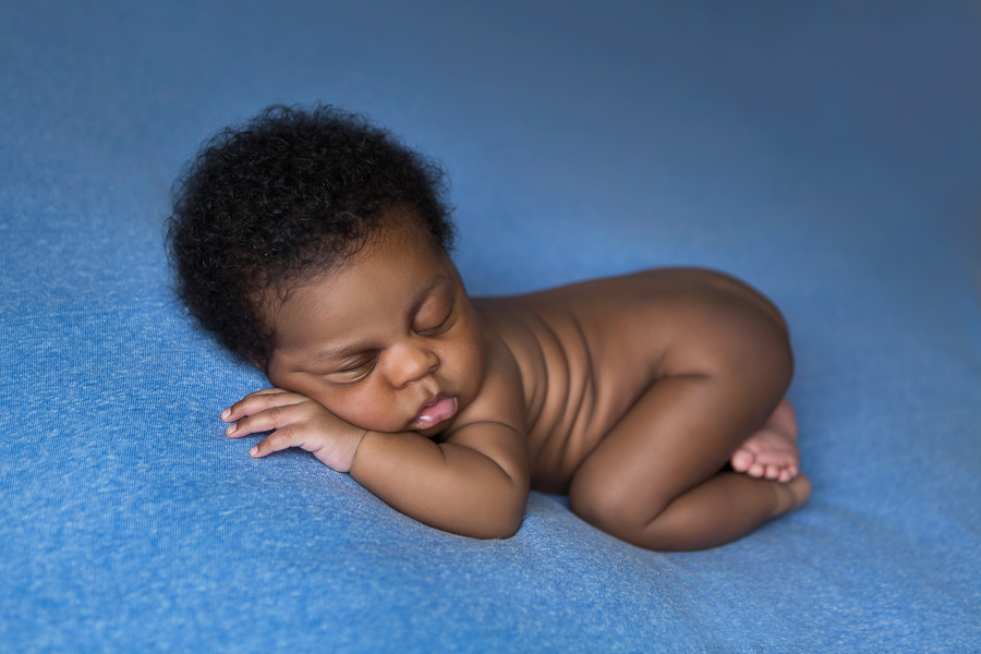 african american newborn sleeping on blue blanket