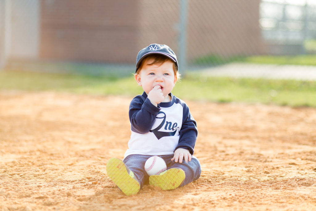 one year old boy on baseball diamond