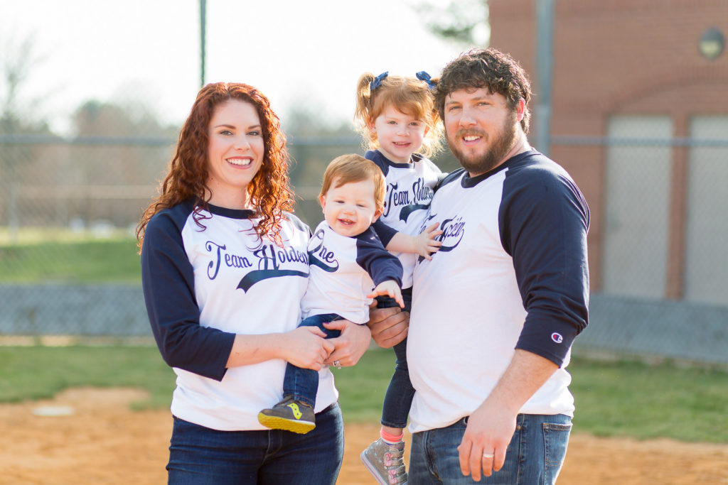 close up portrait of family of four in baseball shirts