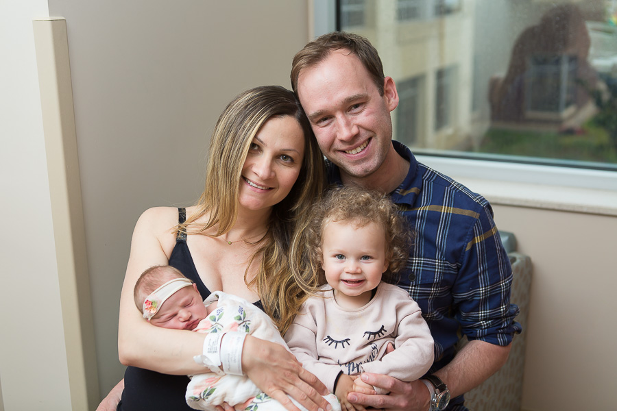 first family photo of four at hospital