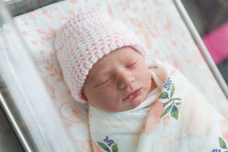 newborn baby sleeping in bassinet at hospital