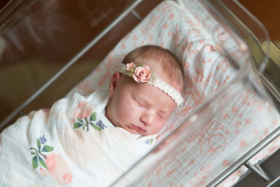 MD newborn baby girl sleeping in bassinet at hospital