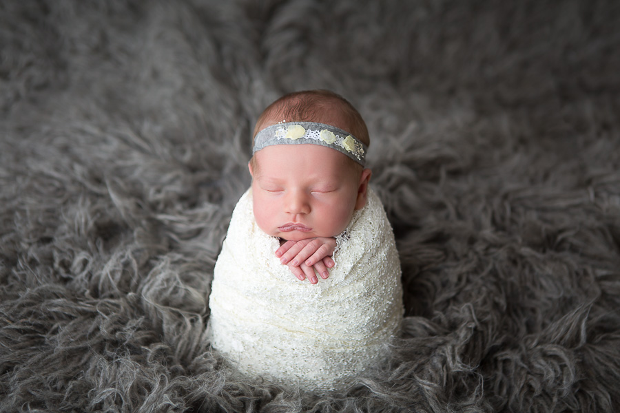 newborn girl in potoato sack pose