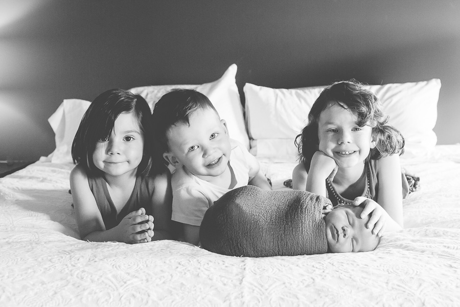 black and white of 4 young siblings