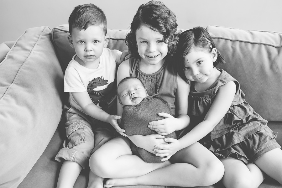 black and white portrait of four young siblings 