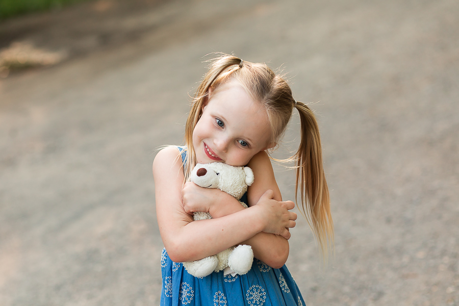 little girl holding soft toy