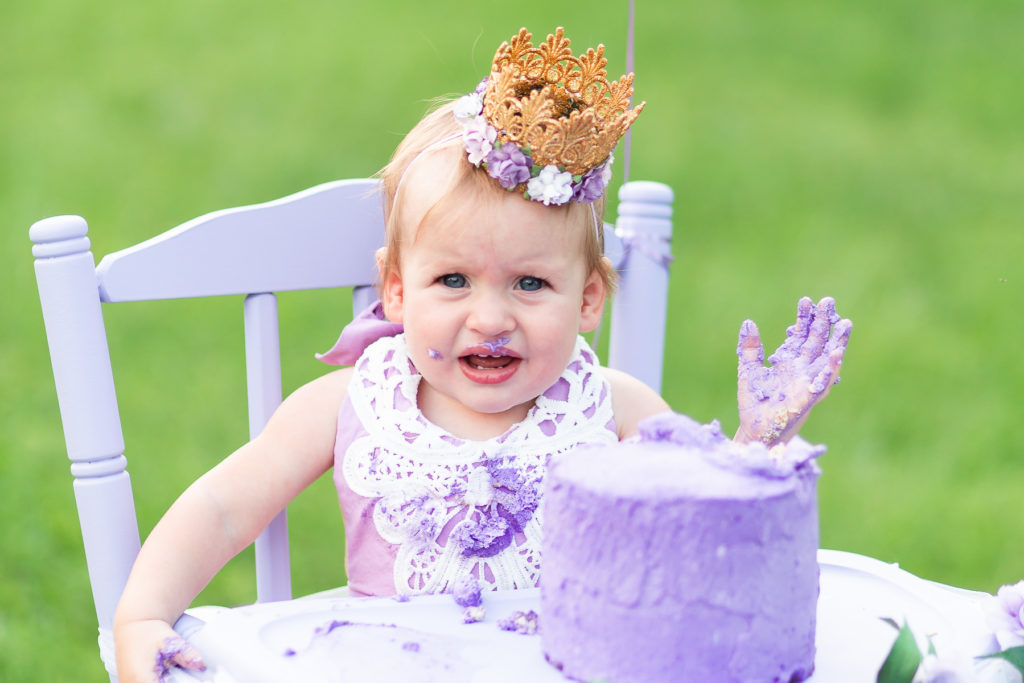 unhappy baby with cake