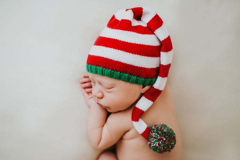 newborn sleeping with elf santa hat newborn session