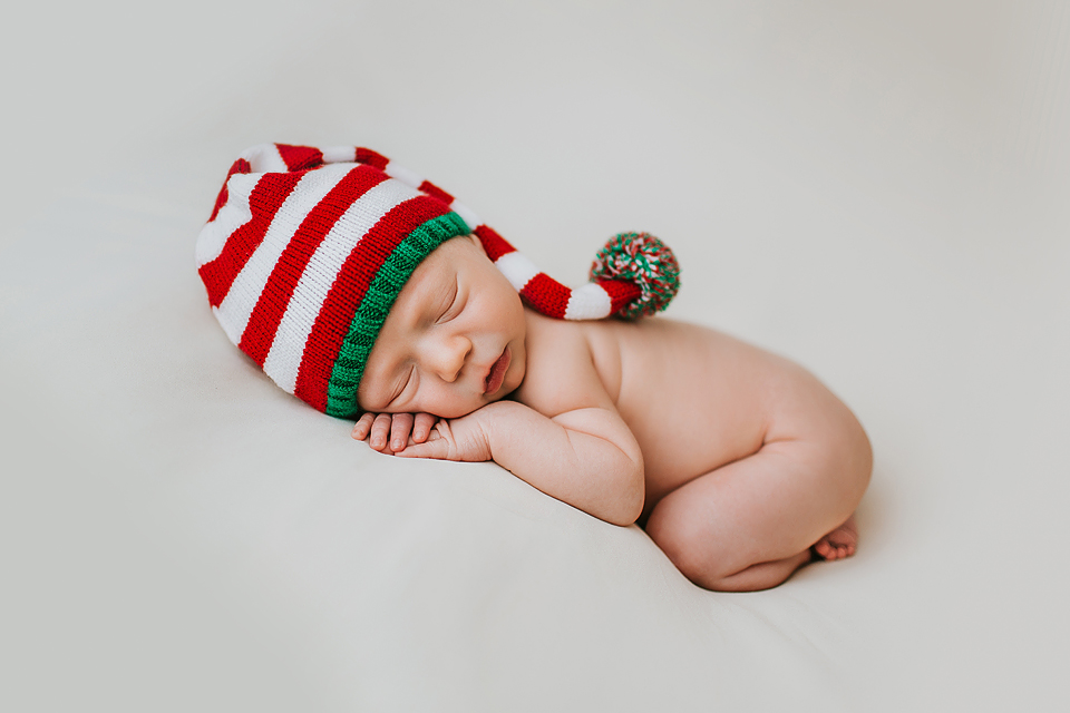 newborn boy in santa christmas hat