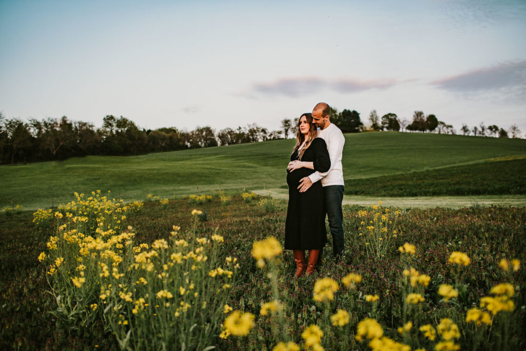 maternity session field of yellow flowers